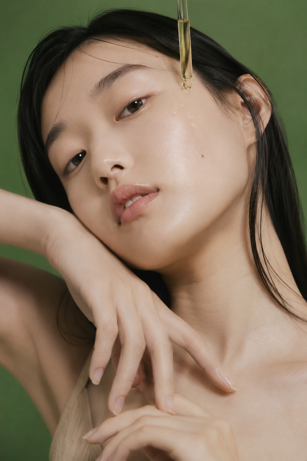 Close beauty portrait with green backdrop and skincare styling